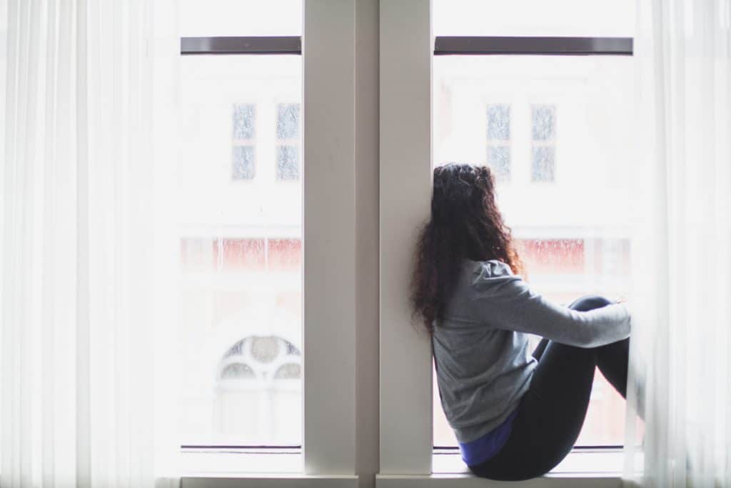 woman sitting in window