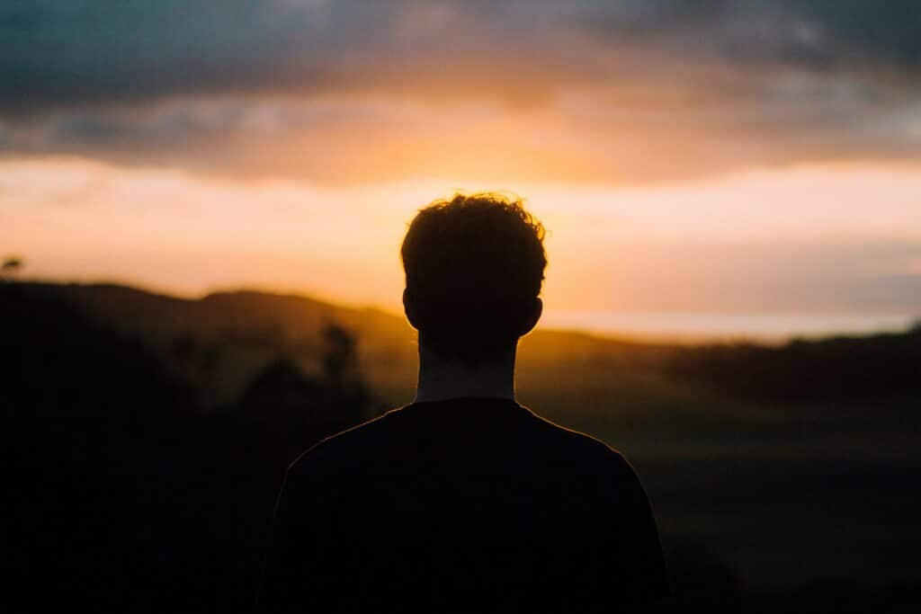 silhouette of a man, gazing into the sky, in touch with various emotions