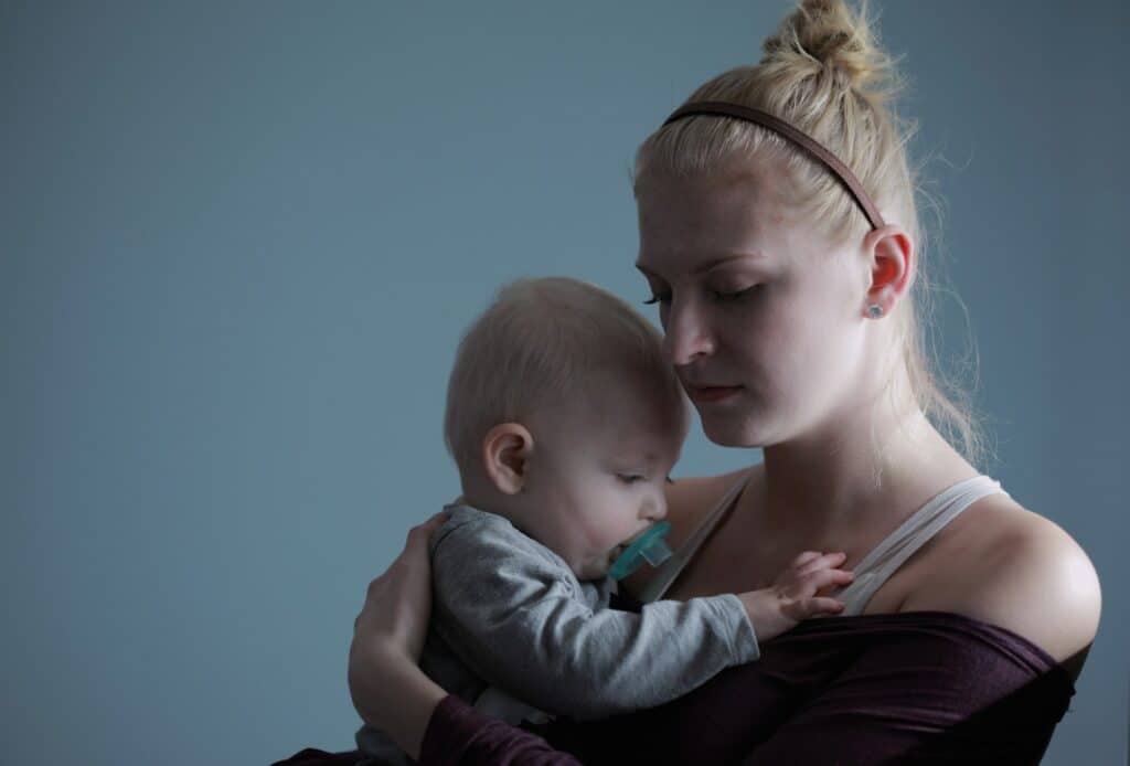 postpartum mother holding a baby