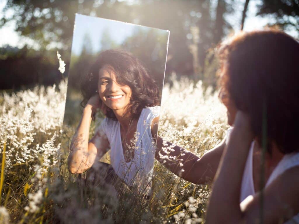 woman in perimenopause looking at herself in the mirror