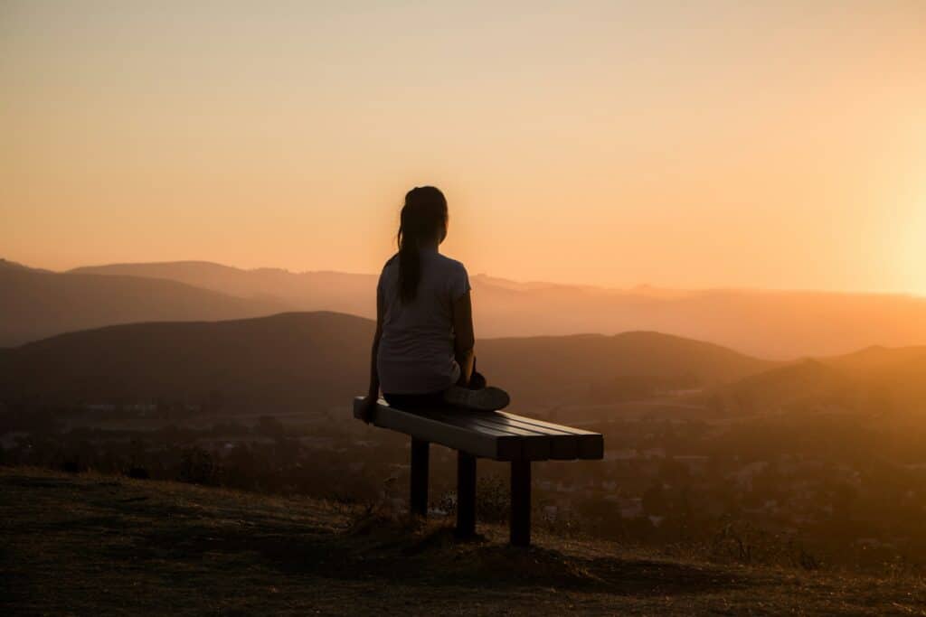 a personal sitting peacefully on a bench